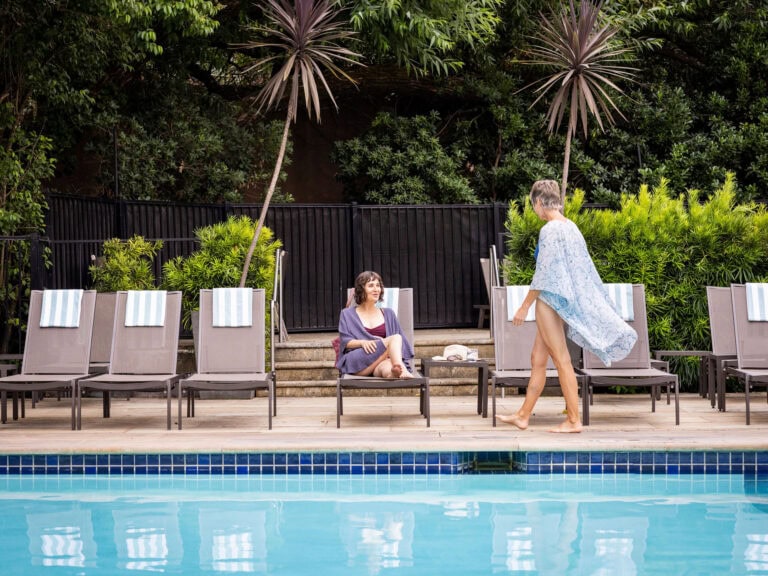 two friends sitting by the pool at the fairmont spa in sonoma