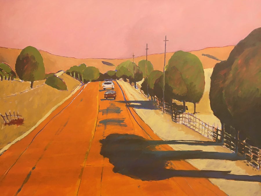 A painting in reds, oranges, and yellows of cars driving down a country road