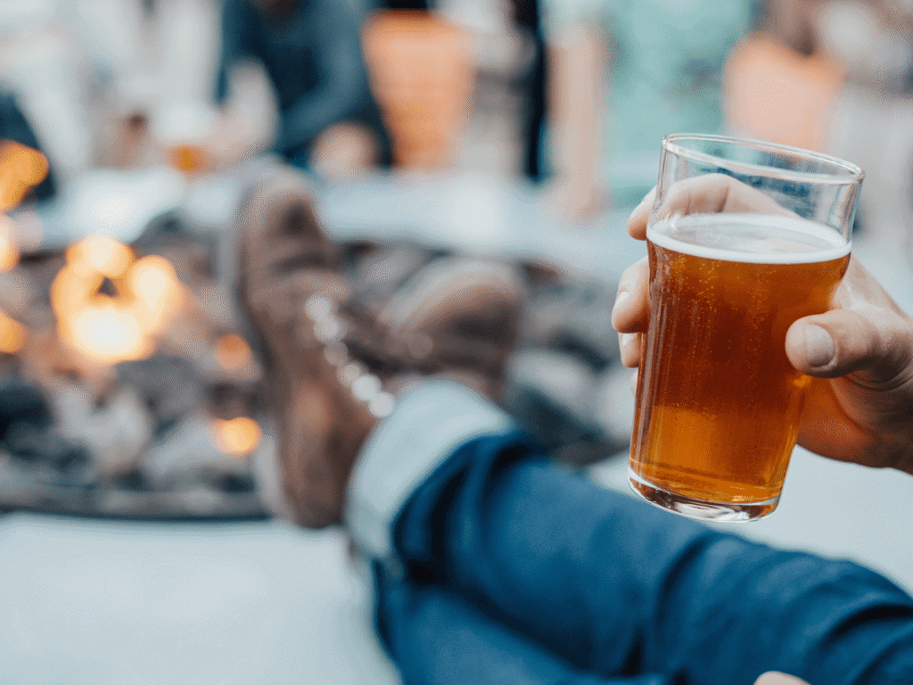visitor kicking their feet up at the firepit while enjoying a glass of beer at brewsters in petaluma