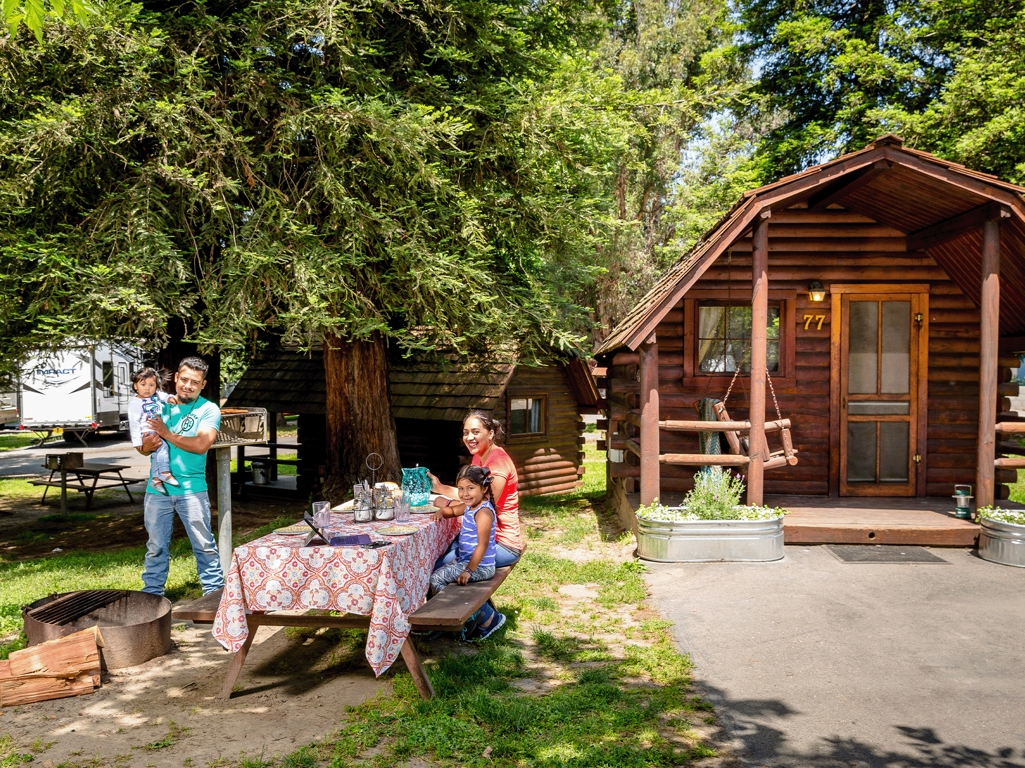 A family sits outside of a cabin in Sonoma County