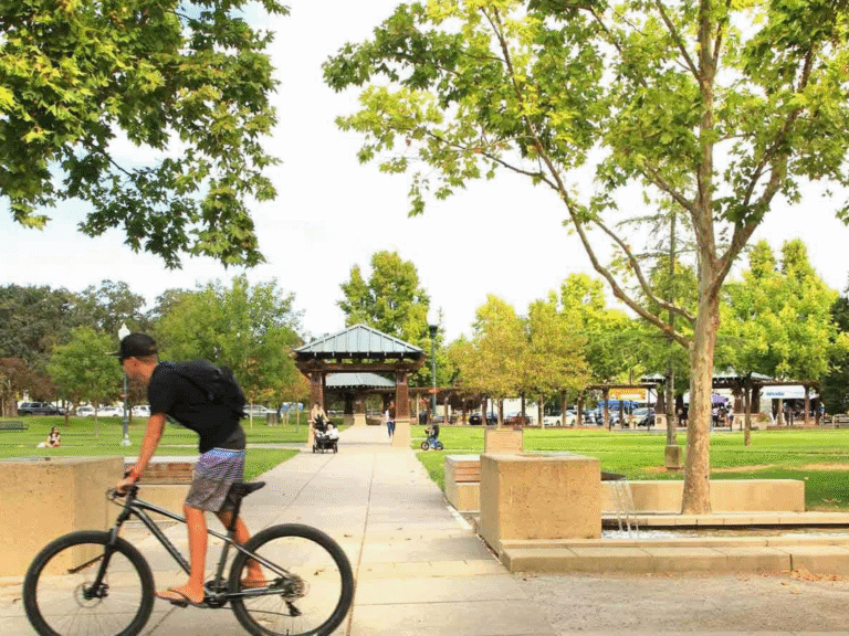 person riding their bike through downtown windsor town green sonoma county