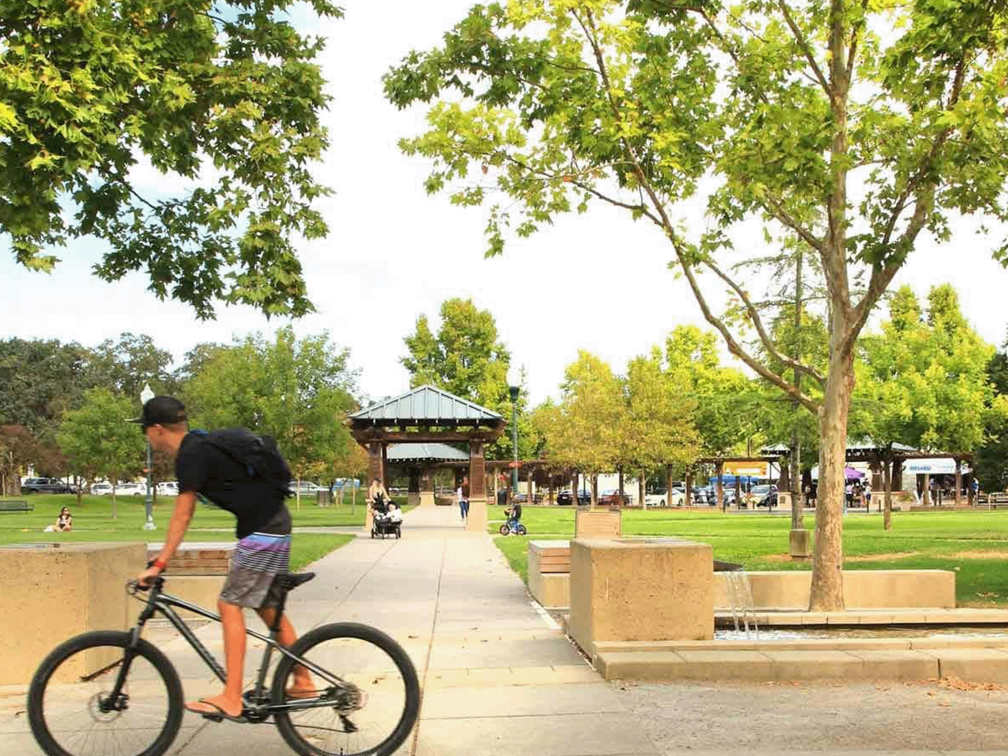 person riding their bike through downtown windsor town green sonoma county