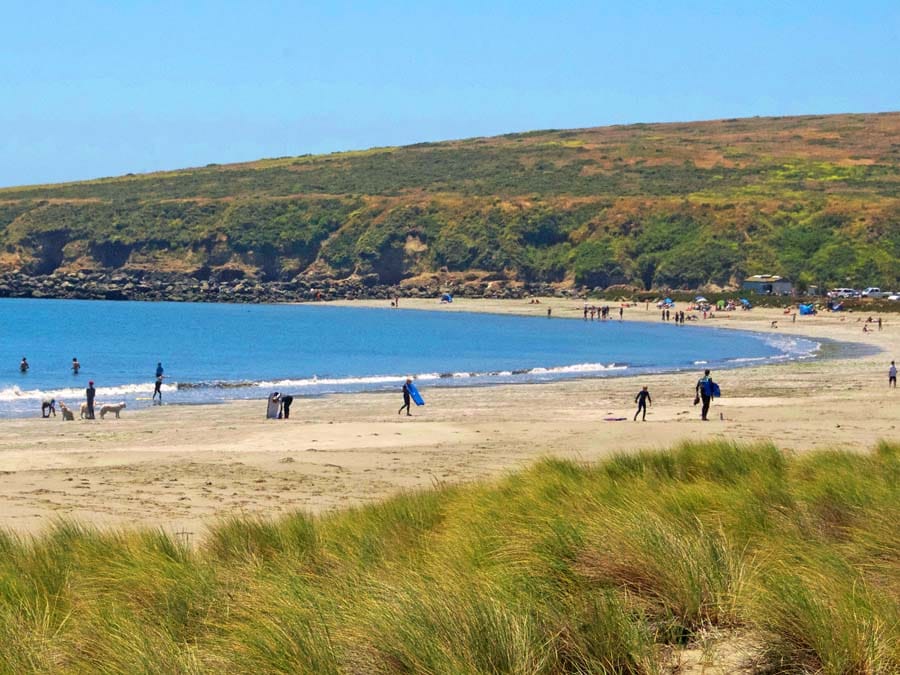 Peopple walk down the sandy beach in Sonoma County