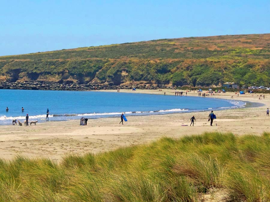 Peopple walk down the sandy beach in Sonoma County