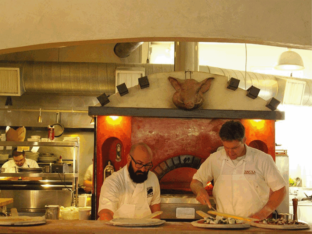 chefs making wood fire pizza at diavola restaurant in geyserville