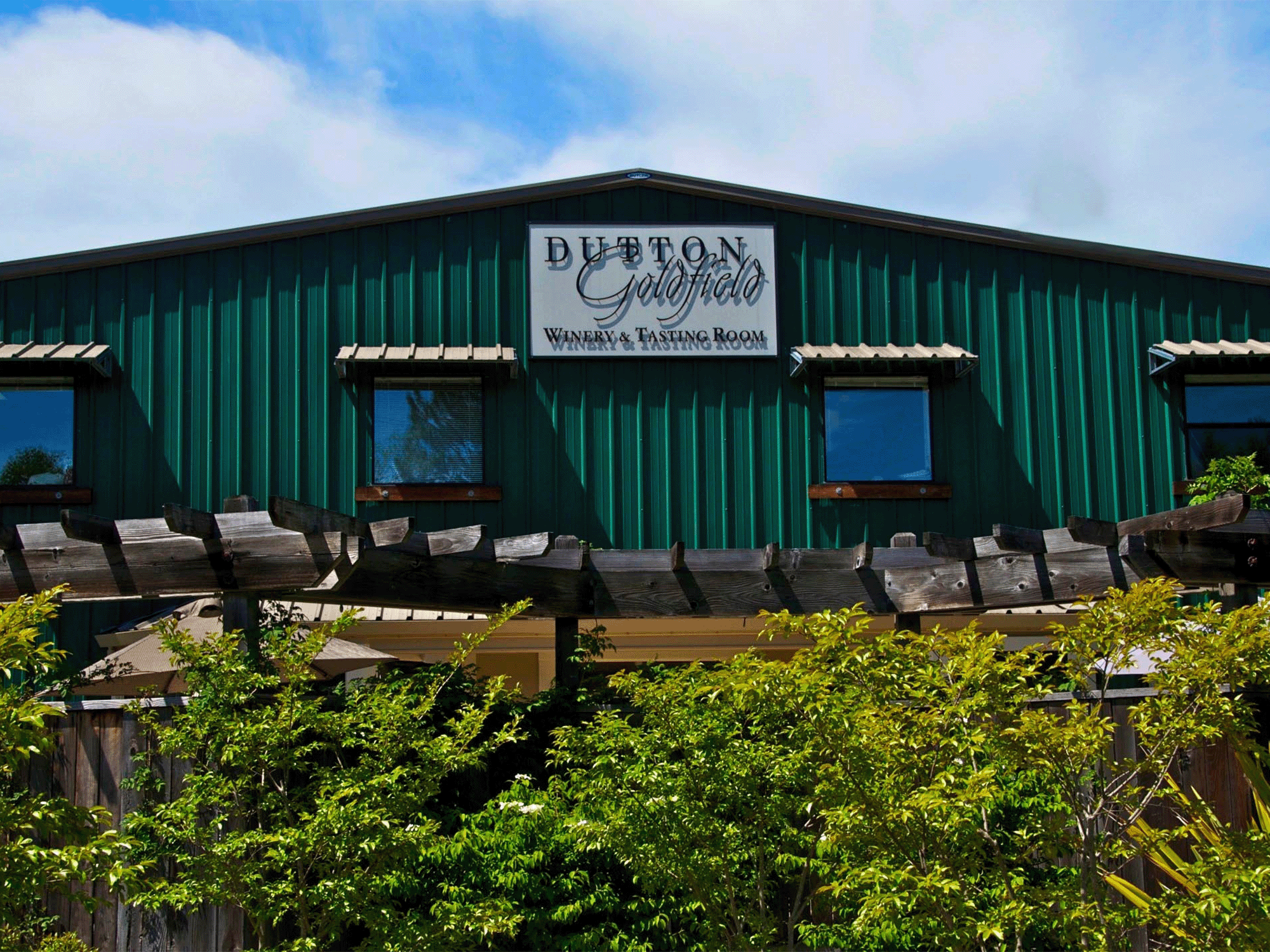 A tasting room with flowers growing in the front