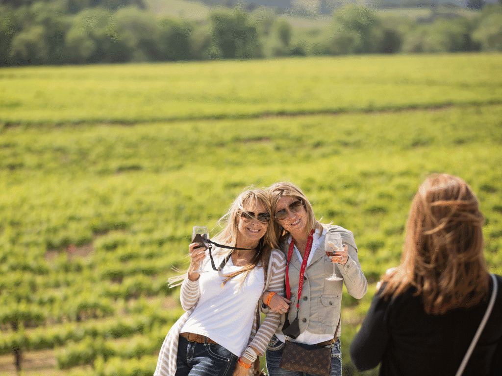 two attendees of the passport to dry creek valley wine event taking a photo in the vineyards