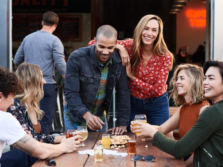 group of people having fun drinking cider and eating popcorn at golden state cider in sonoma county