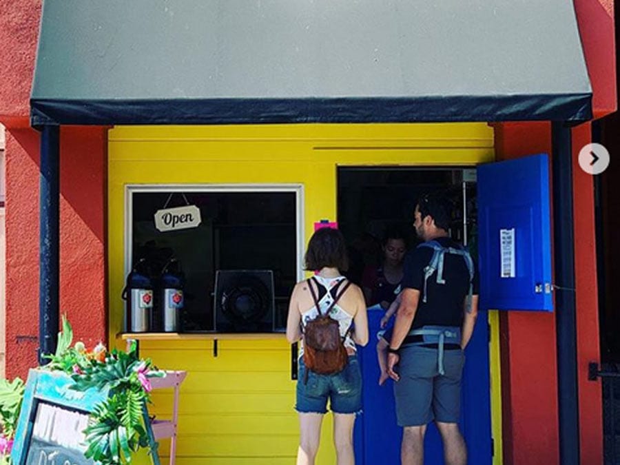 Two people stand in front of the counter where you order