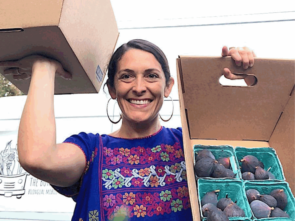 owner of the botanical bus hold boxes of figs in sonoma county