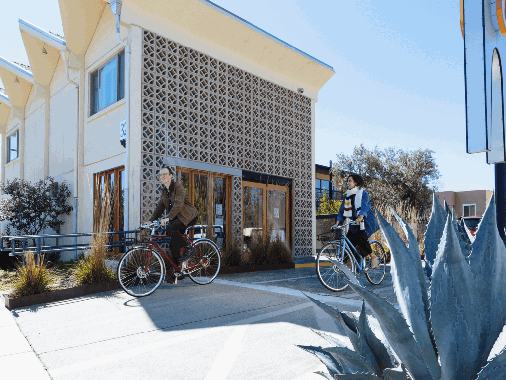 two visitors using the Astro Motels complimentary bikes to go explore santa rosa