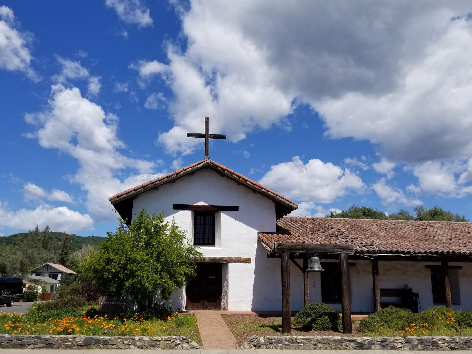 The mission sits on the corner of the Sonoma Plaza on a sunny day