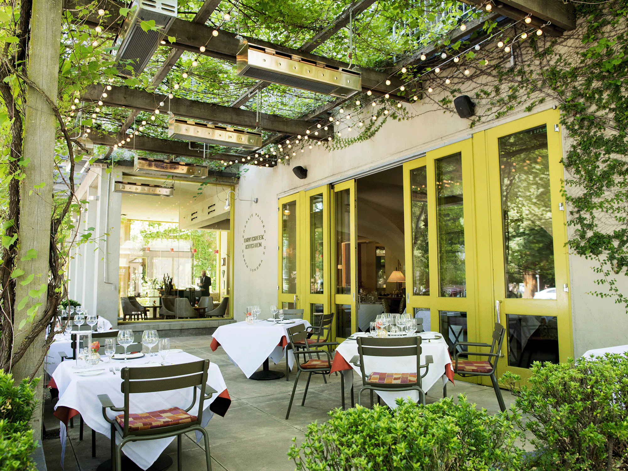 The patio has an arbor with trailing plants