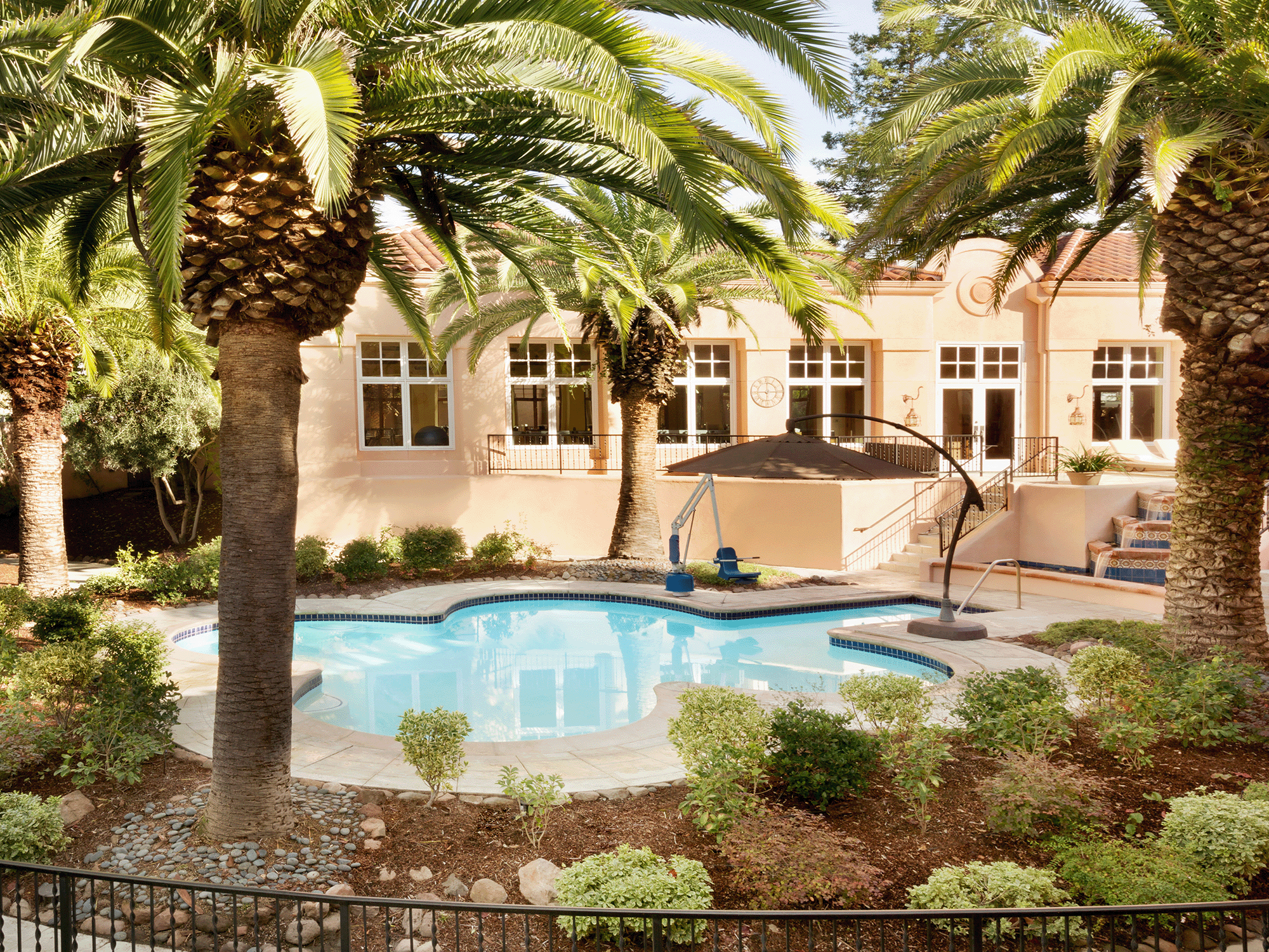 The pool at the Fairmont Sonoma Mission Inn & Spa surrounded by palm trees