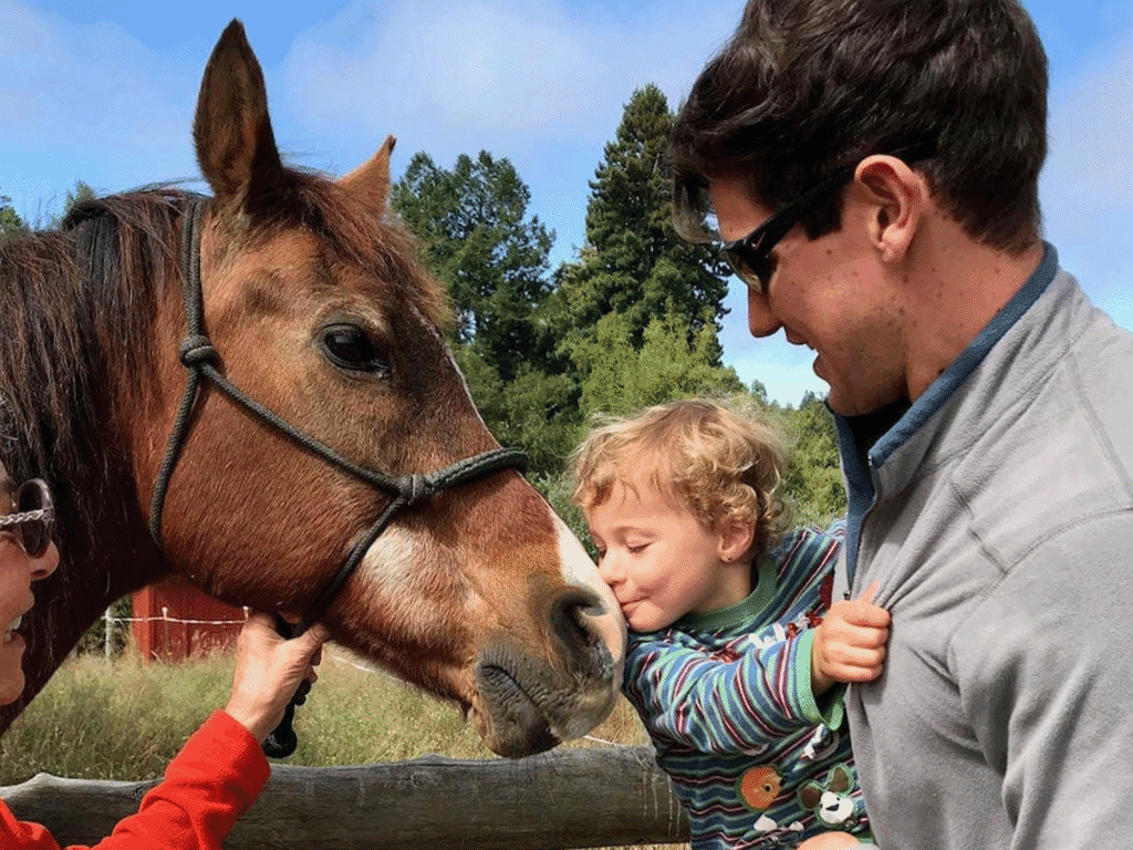 baby kissing a horse at the sonoma county far trails tour