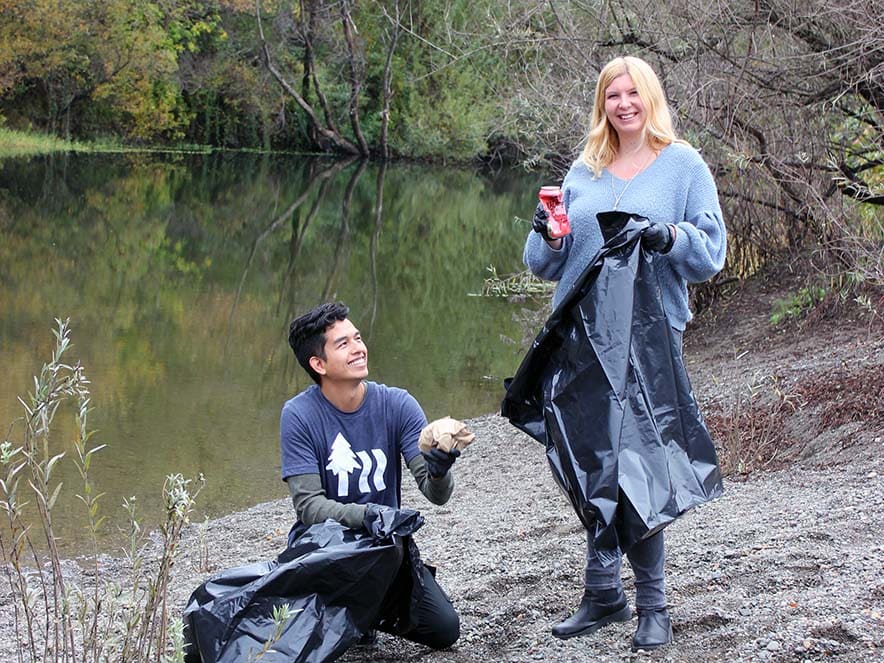 Two People picking cleaning up at Steelhead Beach Regional Park