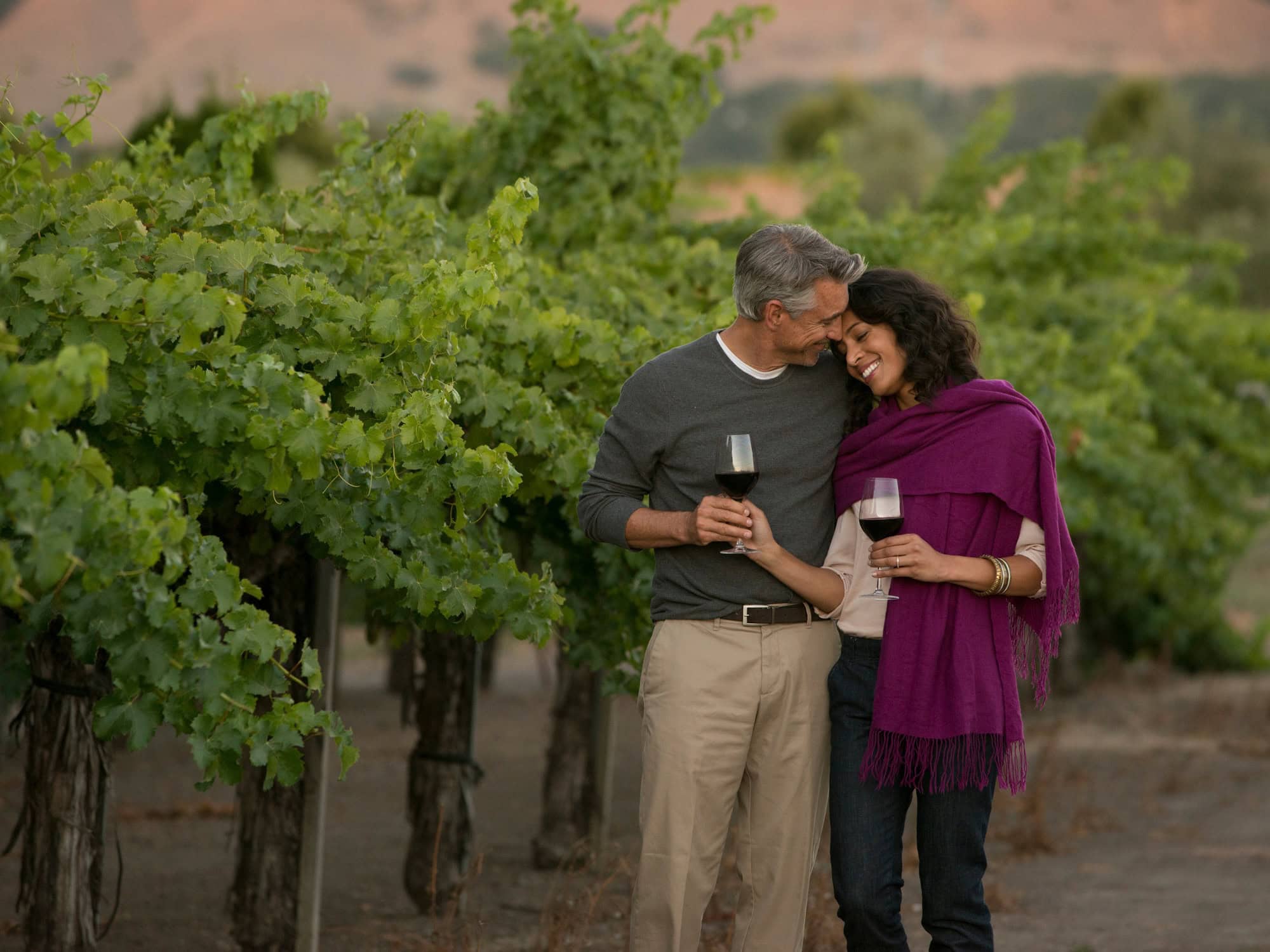 couple enjoying a glass of wine in the vineyards at vintners resort