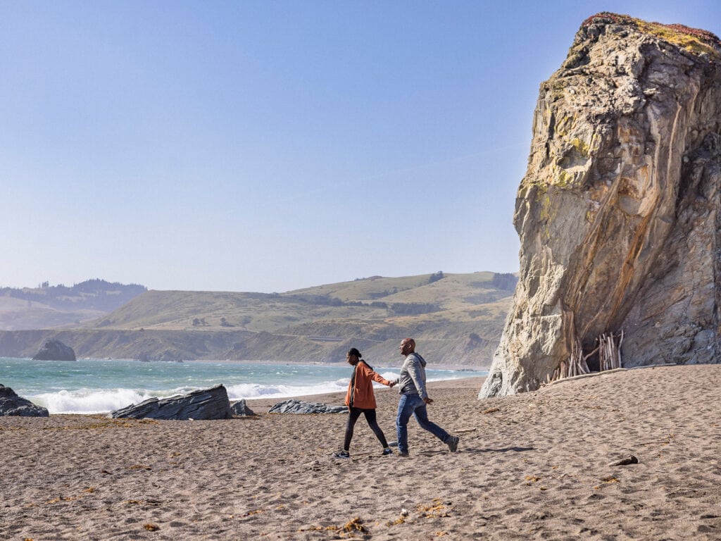 couple walking in the beach of the Sonoma Coast