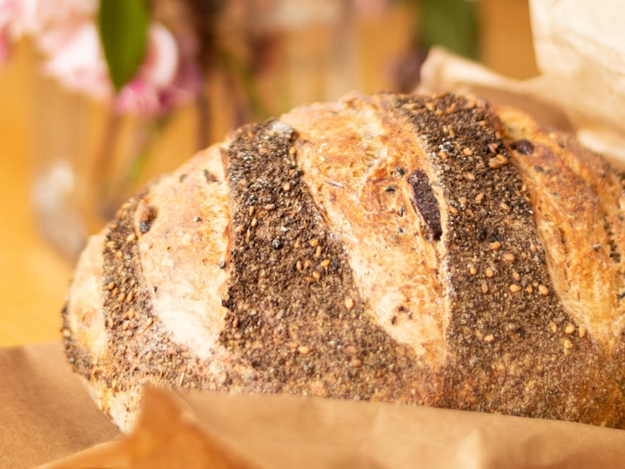 Close up of a seeded loaf of bread at Wild Flour Bakery, Sonoma County, California