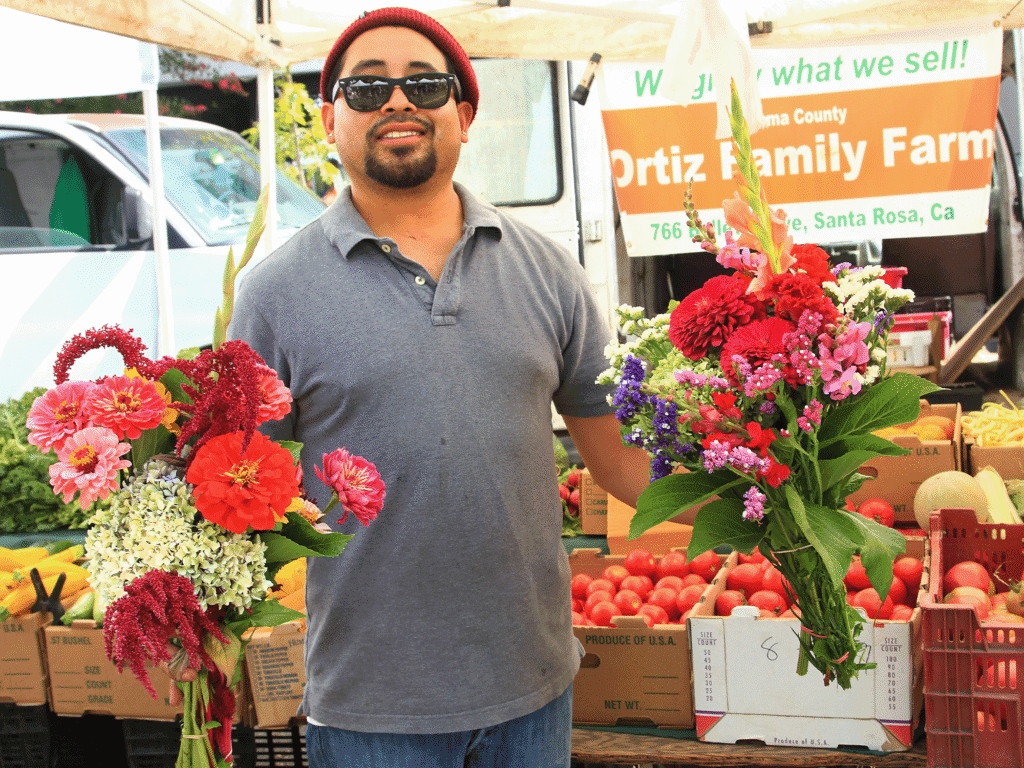 a vendor at windsor certified farmers market selling fresh veggies