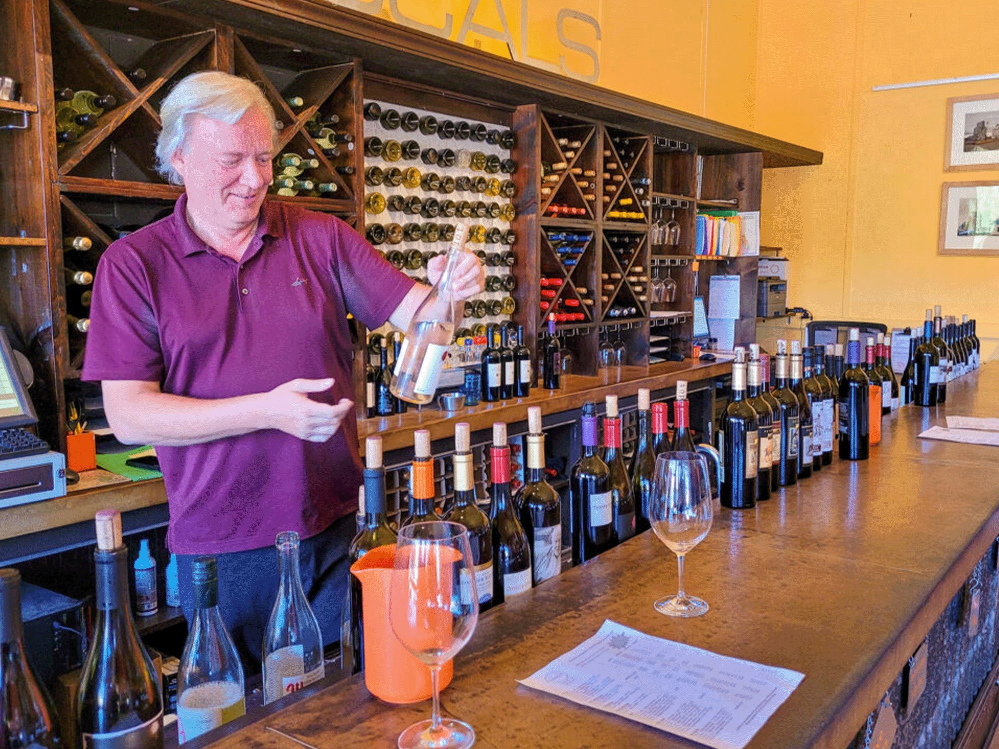 server pouring wine at locals tasting room in geyserville sonoma county