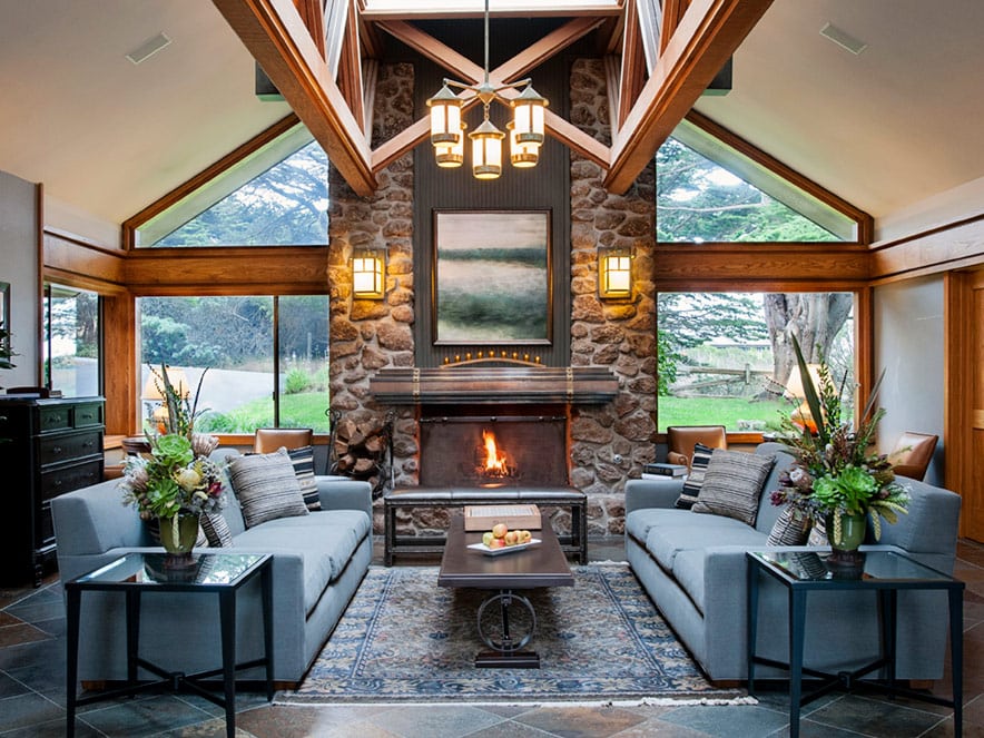 A fireplace and tasteful blue couches at Bodega Bay Lodge in Sonoma County, California