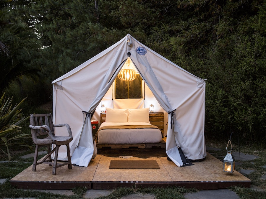Interior tent of rustic-chic glamping tent at dusk