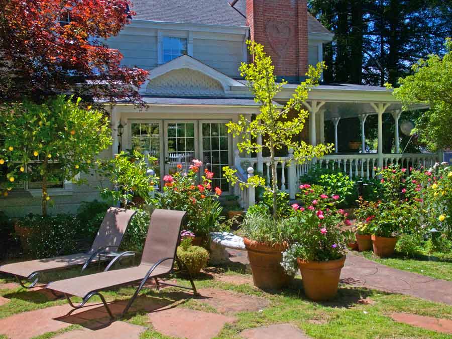 Lounge chairs sit in the garden outside of the inn in Sonoma County