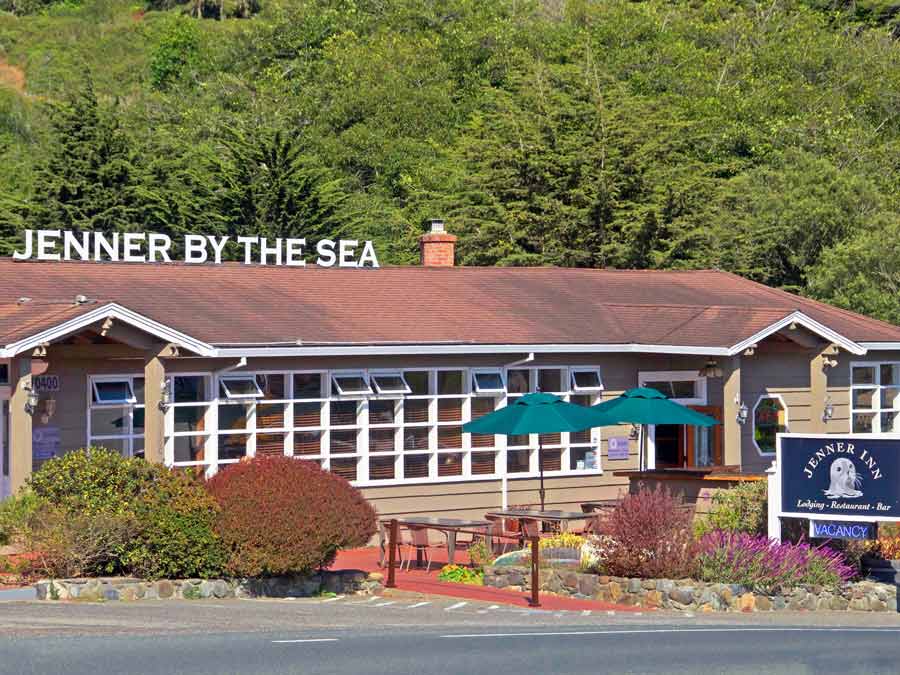 The exterior of the Jenner Inn is surrounded by coastal plants on the Sonoma Coast