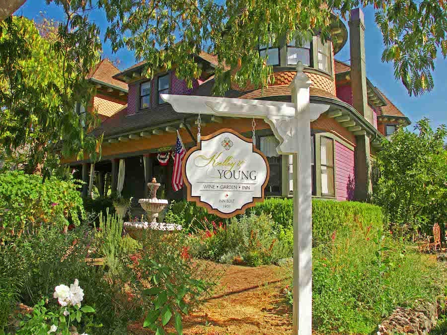 Exterior and sign of the brown-and-tan Victorian-era Kelley & Young Wine Garden Inn in Sonoma County's downtown Cloverdale. 