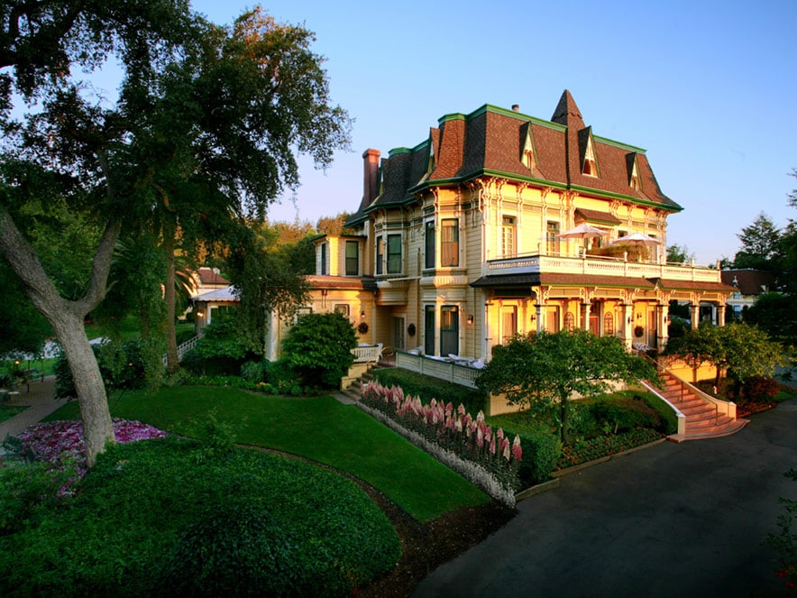 A victorian inn stands next to a colorful garden in Sonoma County, California