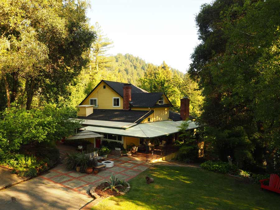 The historic inn from above is surrounded by trees