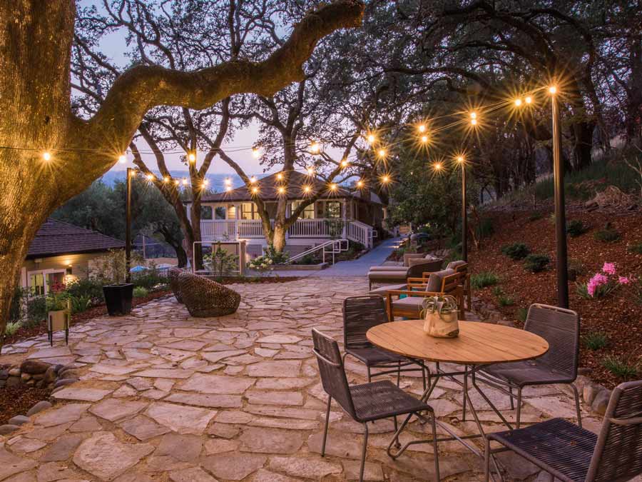 Lights strung over a seating area at dusk