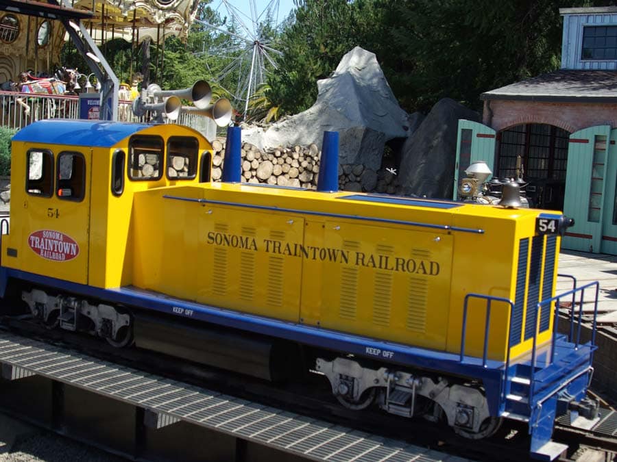 A yellow, miniature steam engine