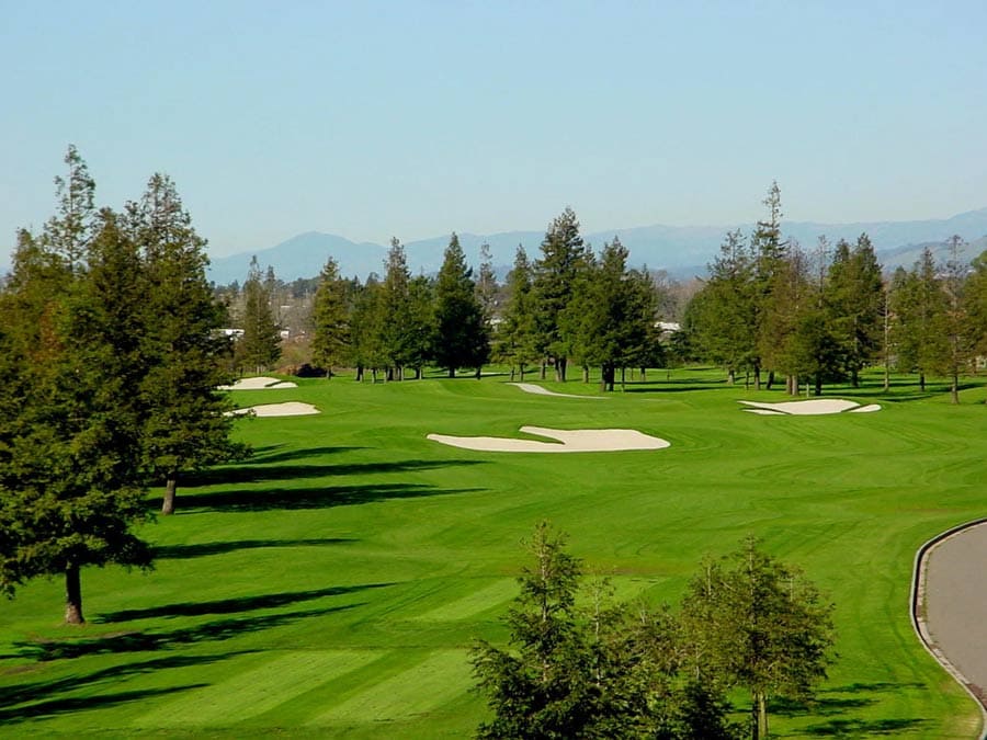 A person swings a golf club in the course in Sonoma County