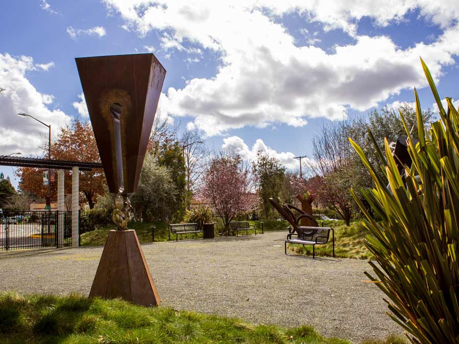 A big, metal scuplture in the garden on a spring day