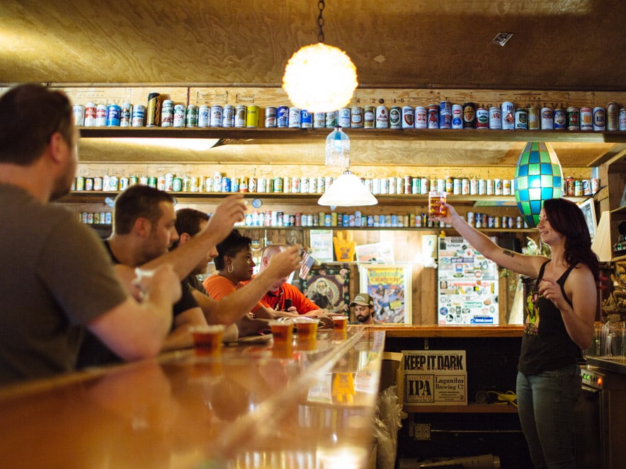 Patrons toast with the bartender at Lagunitas Brewing Co. in Sonoma County