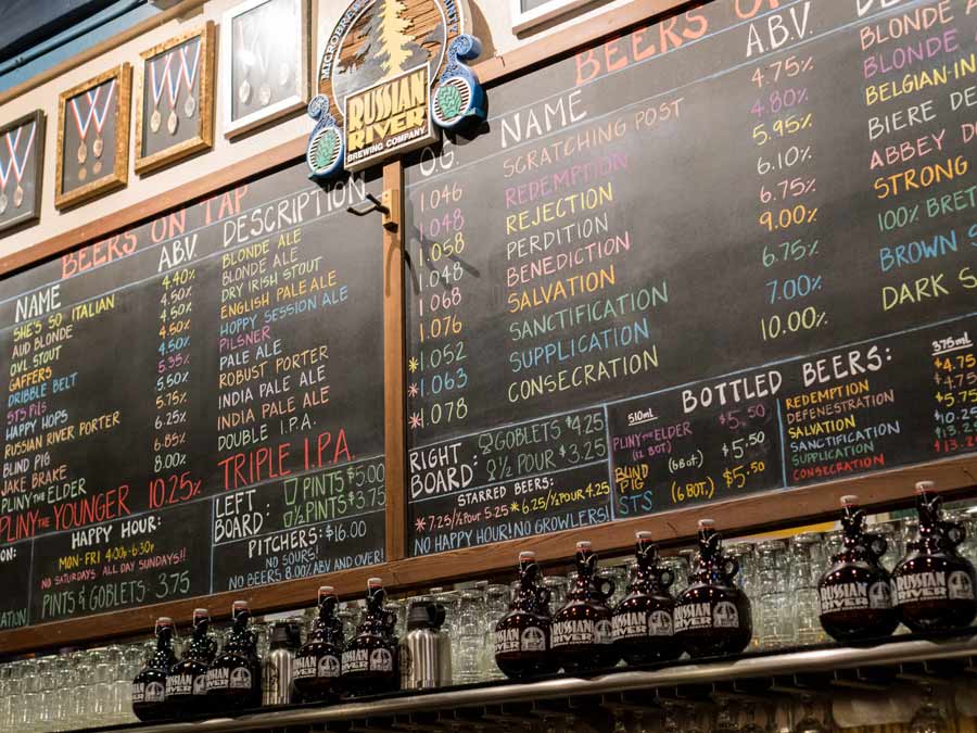 A giant chalkboard has the list of beers