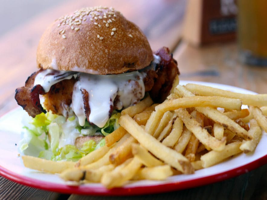 Fried chicken sandwich with goat cheddar, romaine, garlic mayo, bacon, Della Fattoria bun at Brewster's Beer Garden in Petaluma. (Heather Irwin/Sonoma Magazine)