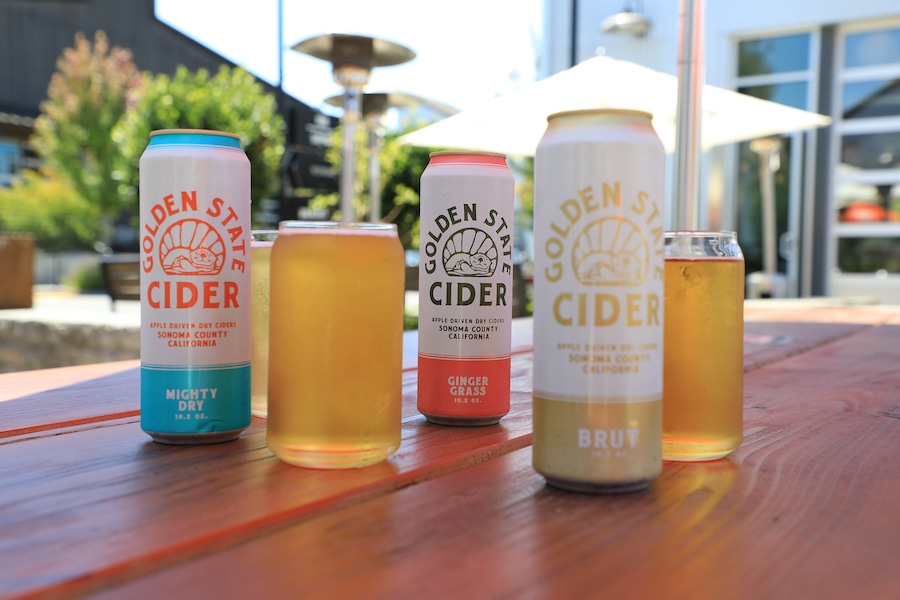 Cans and glasses of Golden State Cider on their tap room patio in Sebastopol, California 