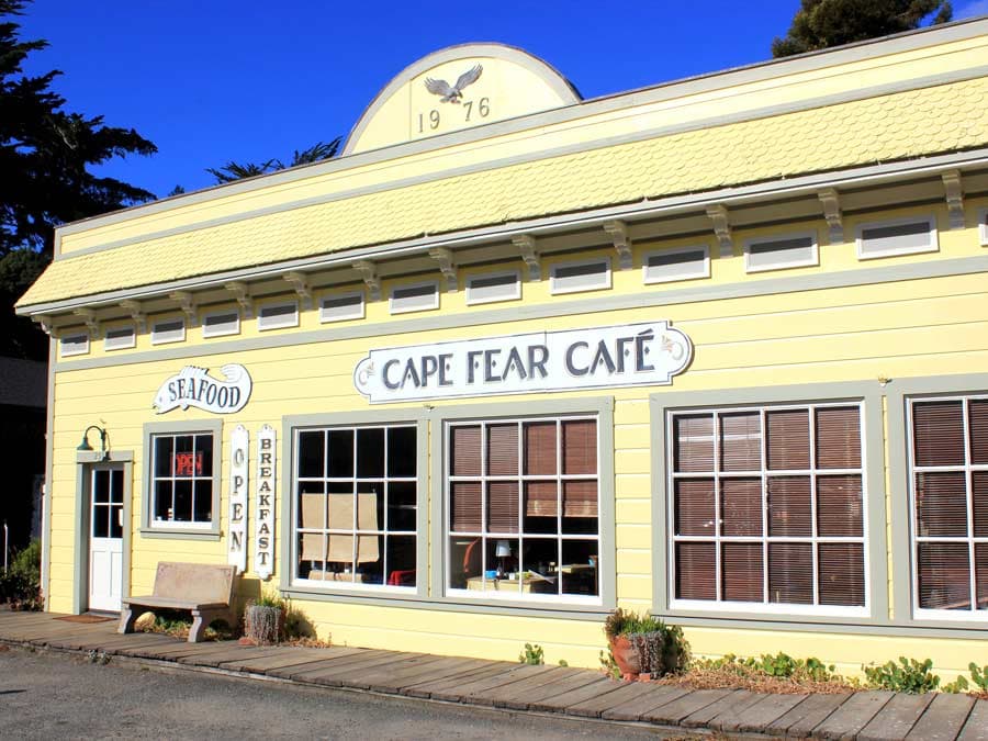 The yellow restaurant building shines against a bright, blue sky