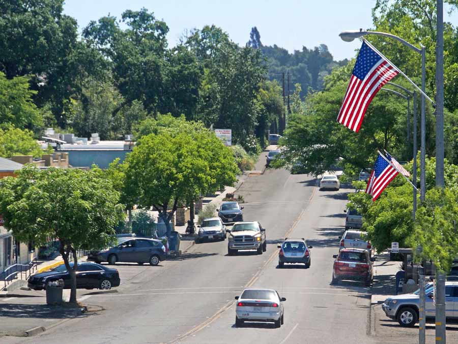 Front Street is the main street through town lined with shops and American flags in Forestville, Sonoma County