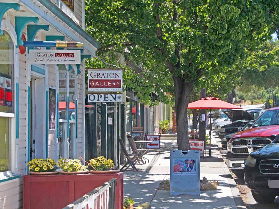 A sidewalk in Graton in front of the gallery is lined with flowers in Sonoma County