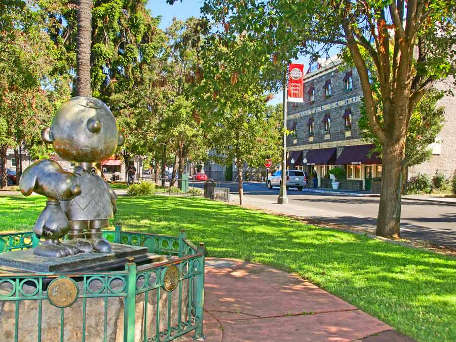 A bronze statue of Charlie Brown and Snoopy in the park in Railroad Square, Sonoma County