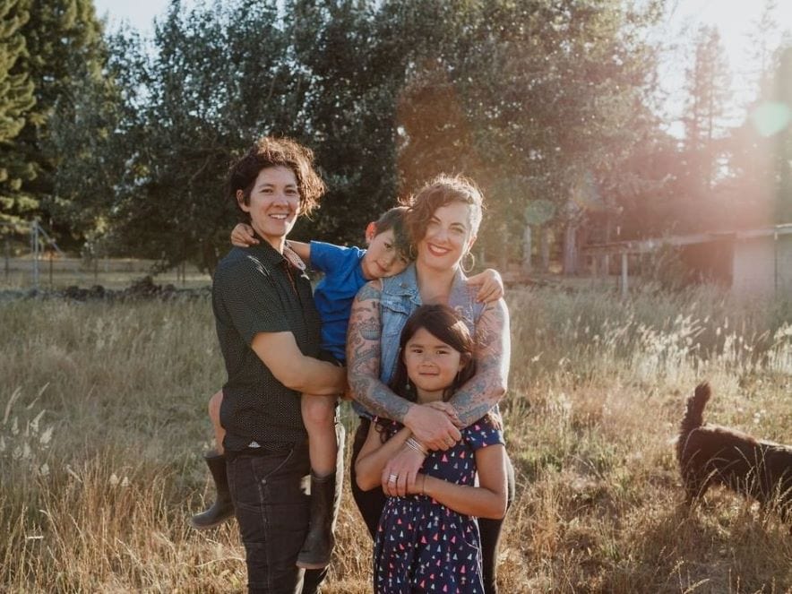 picture of family standing together in field