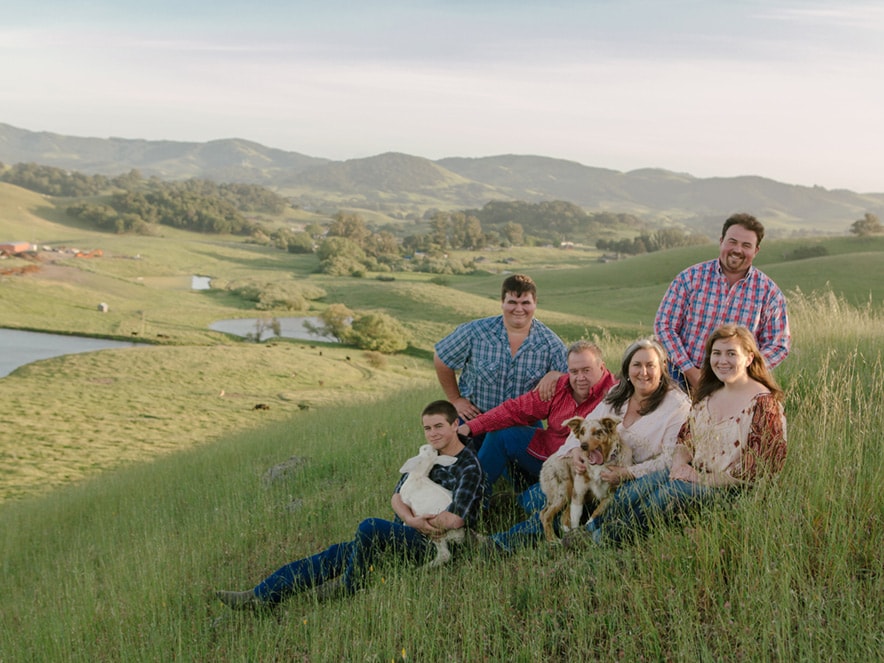 The Achadinha family poses for a portrait in the fields of their pastures on their dairy farm in Petaluma, California