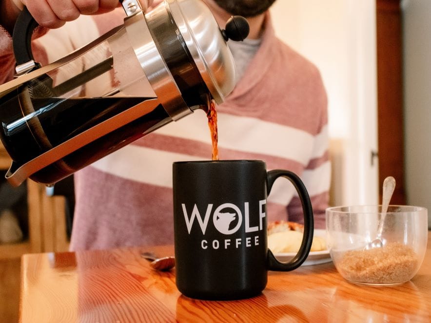 Picture of man pouring coffee at Wolf Coffee