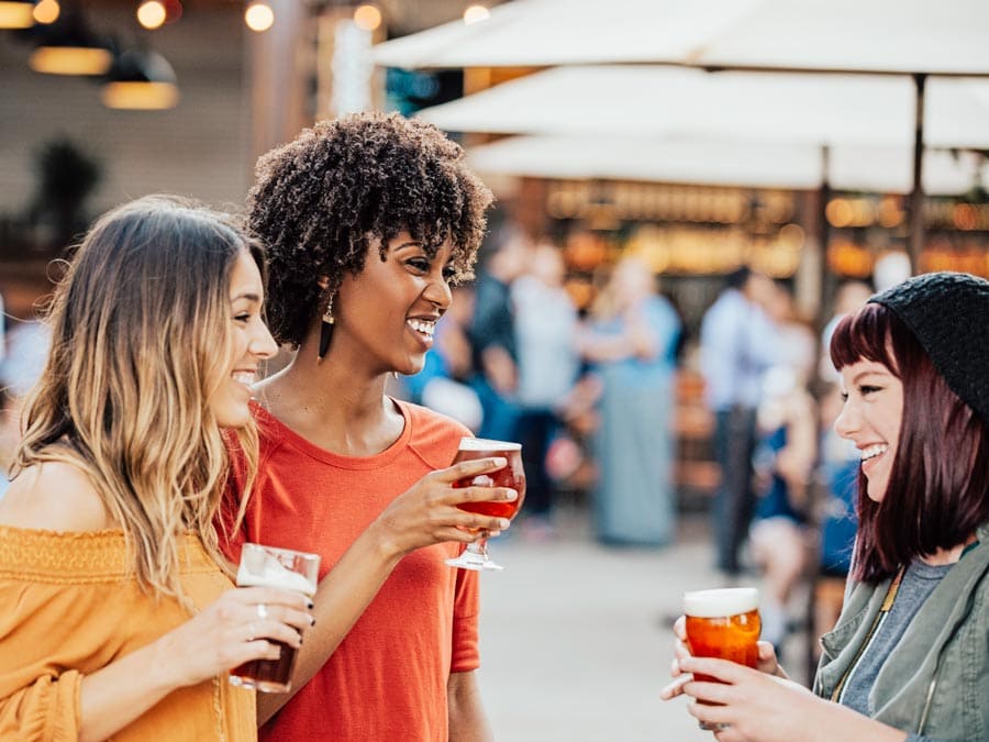 A group of women enjoy beers on the patio at Brewsters