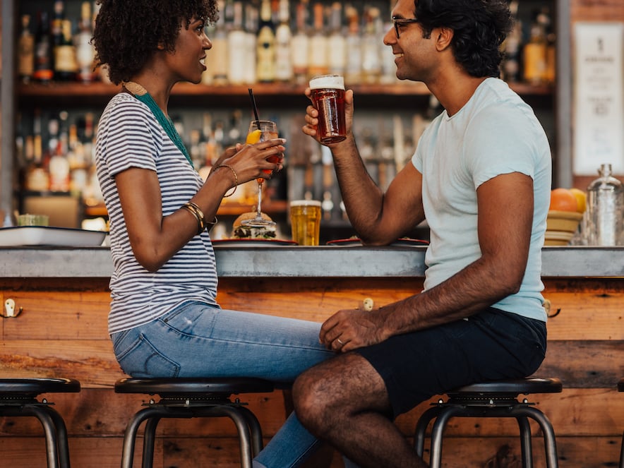 Picture of couple sitting at bar having drinks together