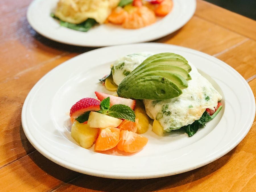 An omelette topped with avocado and served with fresh fruit at Costeaux French Bakery, Healdsburg